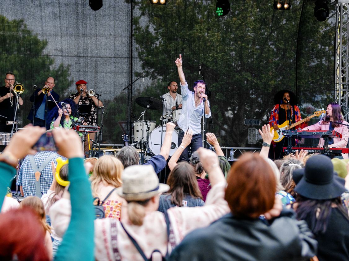 Band on stage in front of large crowd