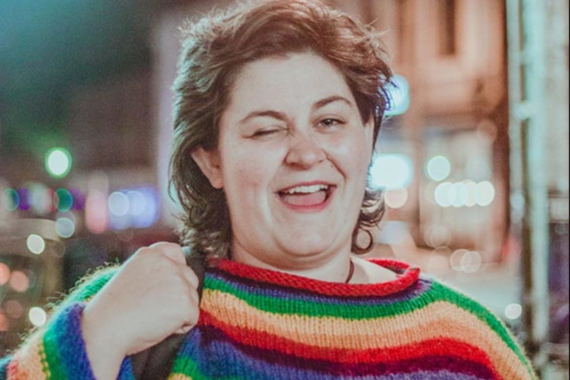 Woman in colourful top winking at the camera