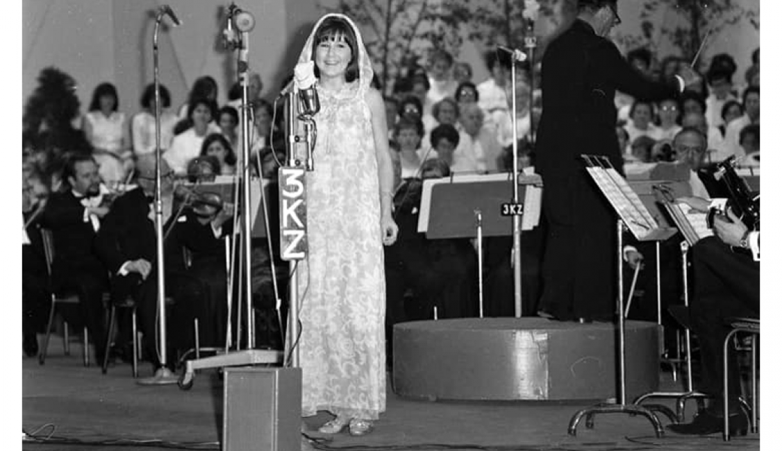 you woman standing on stage