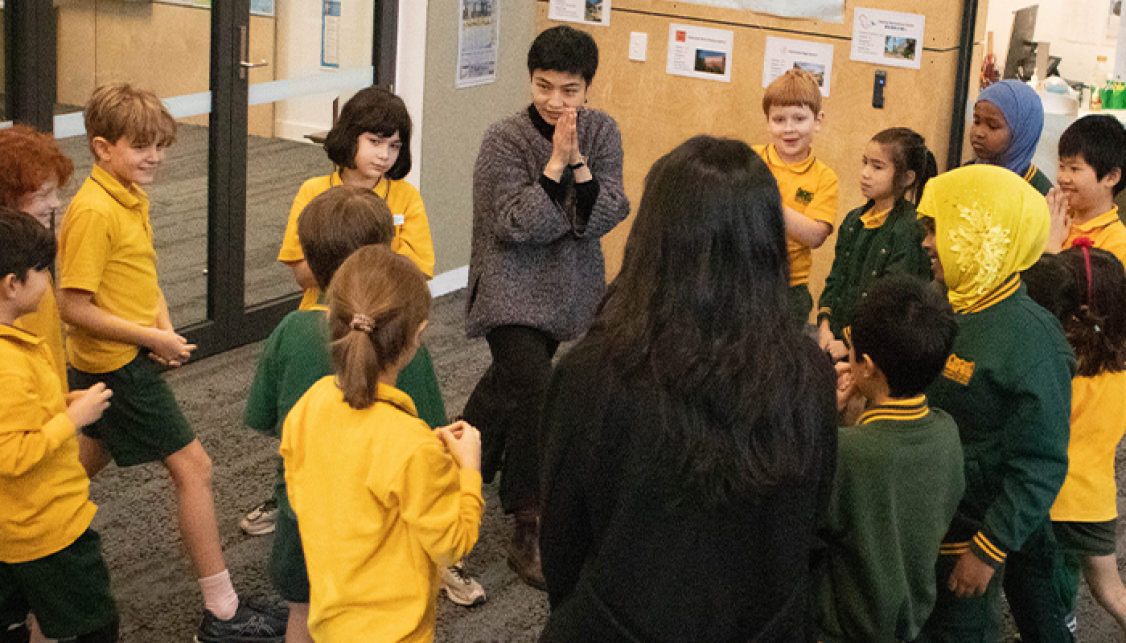 Women in a group of kids doing an activity