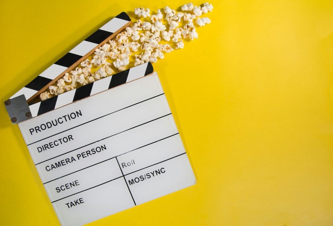 clipboard and popcorn on yellow background