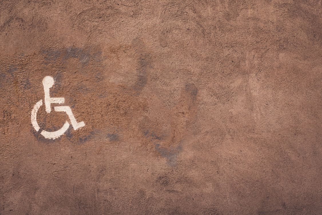 Icon of wheelchair user painted on cement
