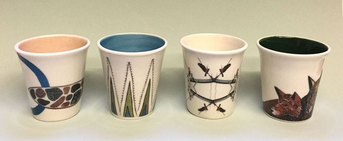 Set of four mugs with drawings on them